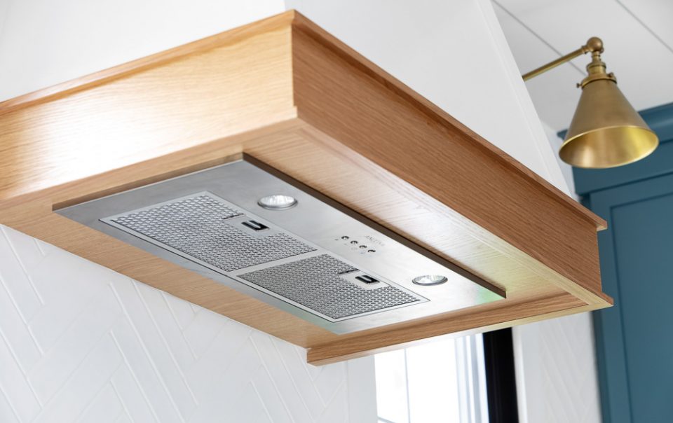 Stove vent trimmed in wood veneer